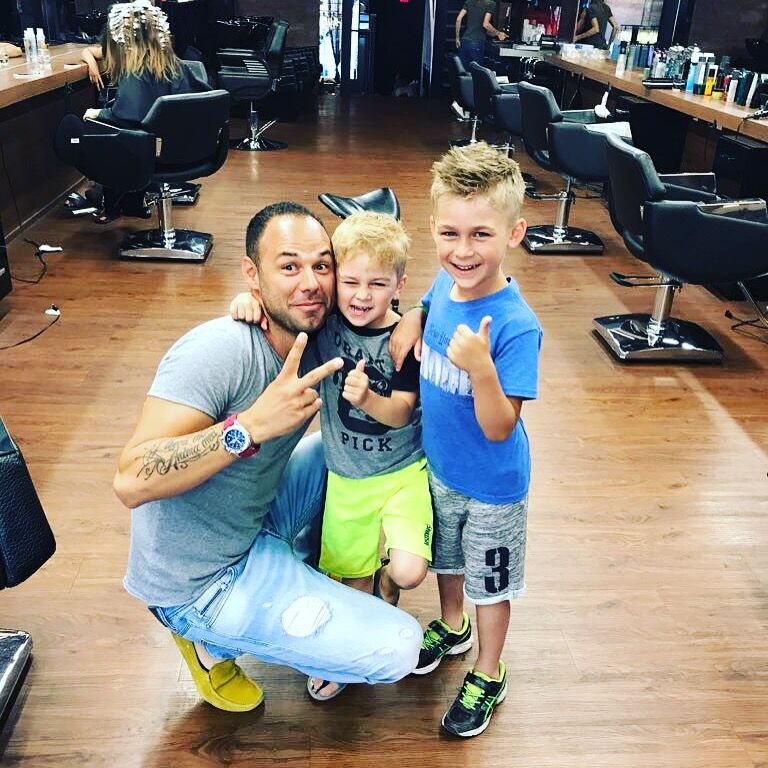 Ergys with 2 young clients at the salon