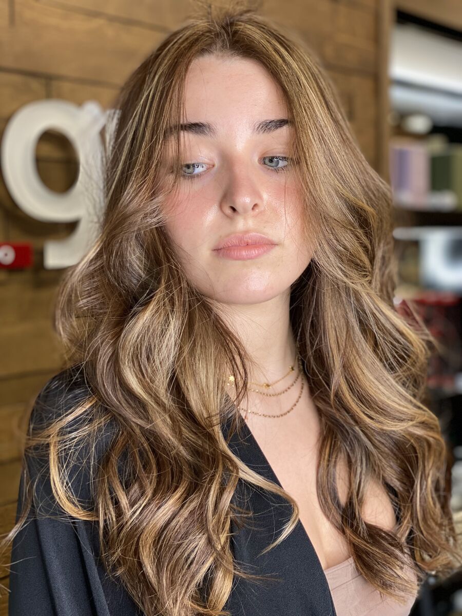 Brunette balayage with caramel pieces around the face