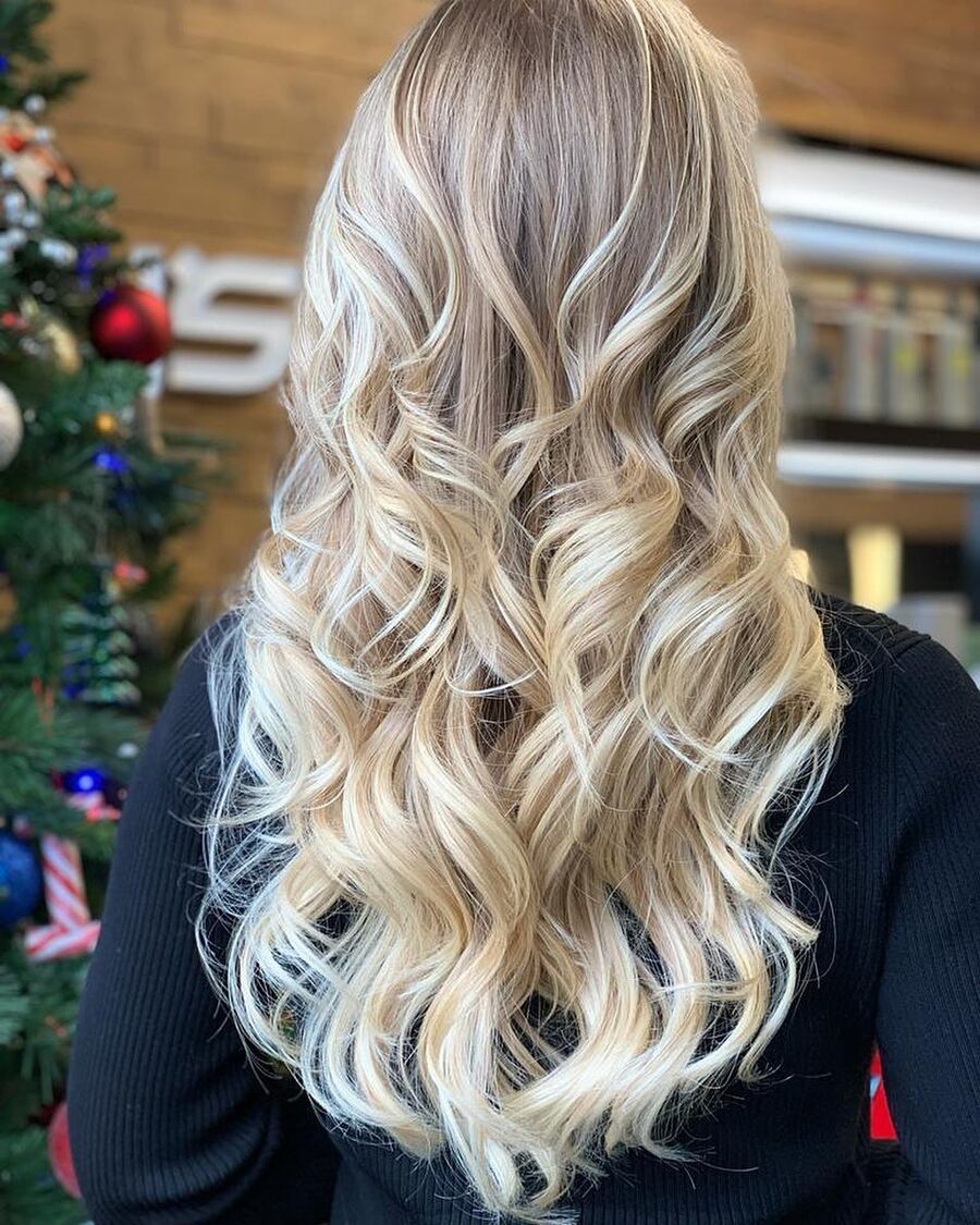Bright blonde hair styled in soft curls