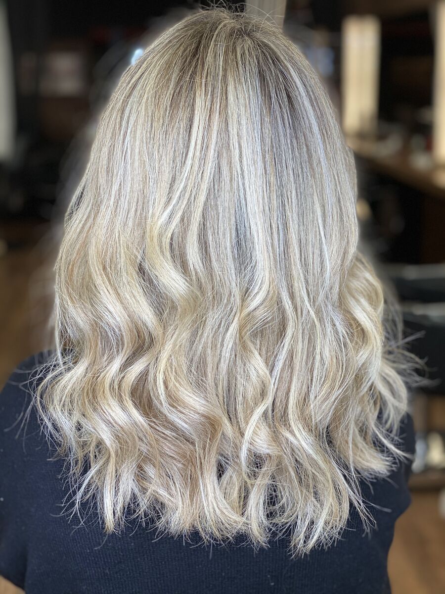 Shoulder-length blonde hair styled in soft waves