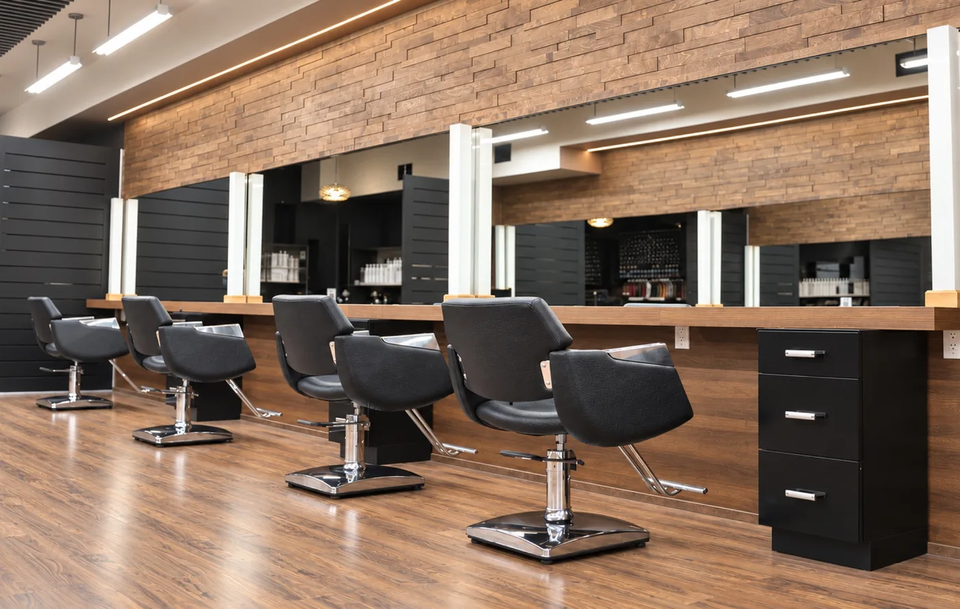 Styling chairs, long mirrors and wood walls inside Ergys Studio